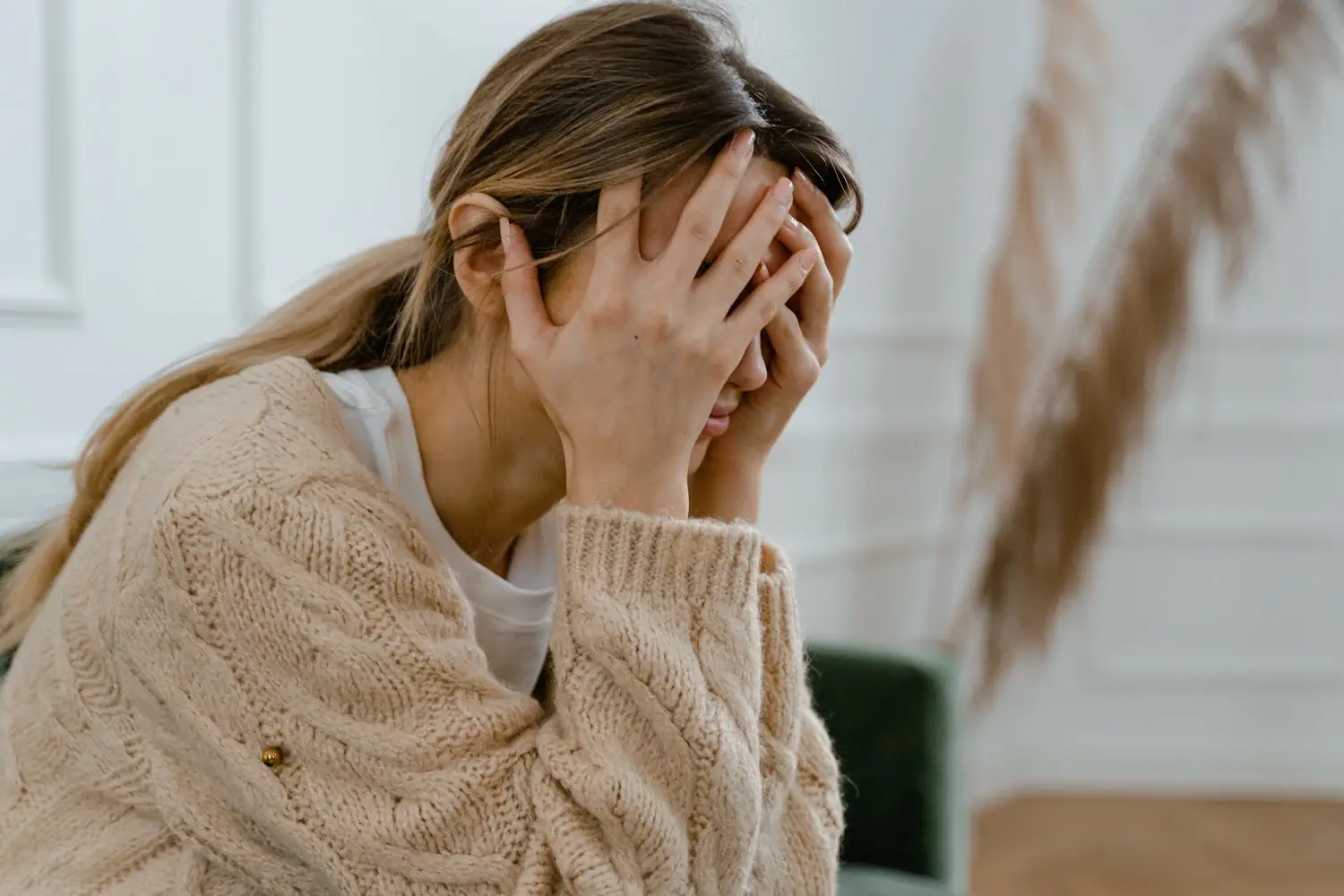 A woman with her head in her hands